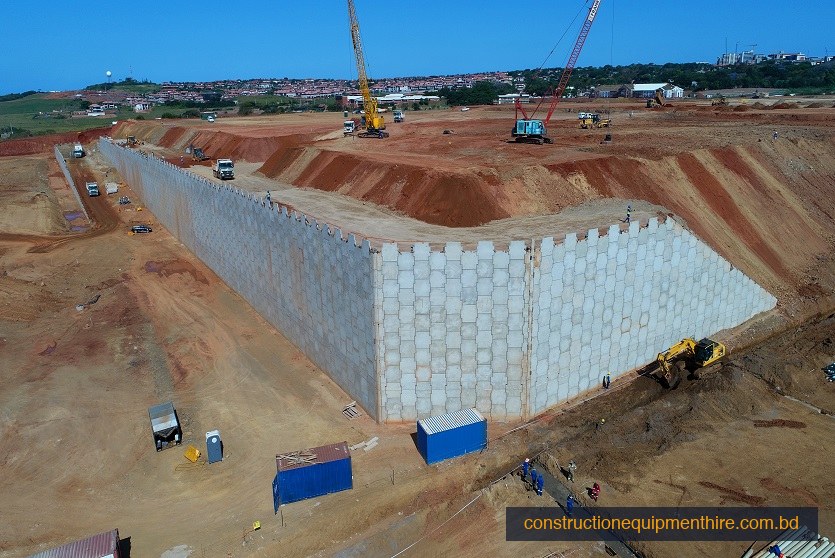 Aerial drone view — large-scale RR Wall project with crane & excavator