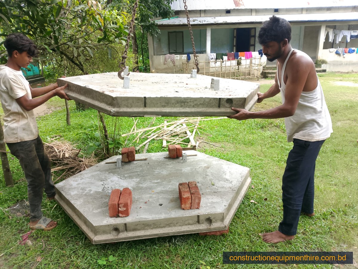Workers demoulding completed precast hexagonal block